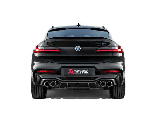 Rear view of a black BMW X4M with an Akrapovič exhaust with twin pipes each side & an Akrapovič carbon fibre rear diffuser fitted