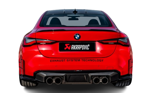 Rear view of a red BMW M3 with an Akrapovic exhaust, with twin pipes each side, & a high gloss black rear diffuser fitted