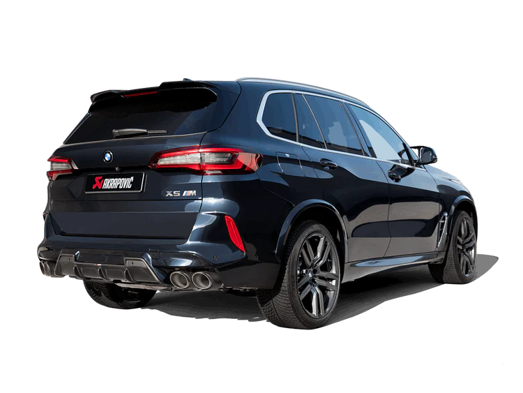 Offside rear view of a dark blue BMW X5M with an Akrapovič twin pipes each side exhaust & an Akrapovič carbon fibre rear diffuser fitted