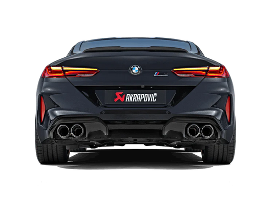 Rear view of a black BMW M8 with an Akrapovič exhaust, with twin pipes each side, fitted