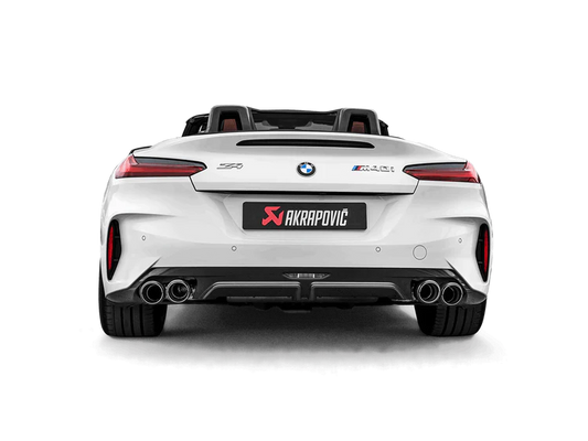 Rear view of a white BMW Z4 M40i with an Akrapovič exhaust, with twin pipes each side, and a carbon fibre rear diffuser fitted