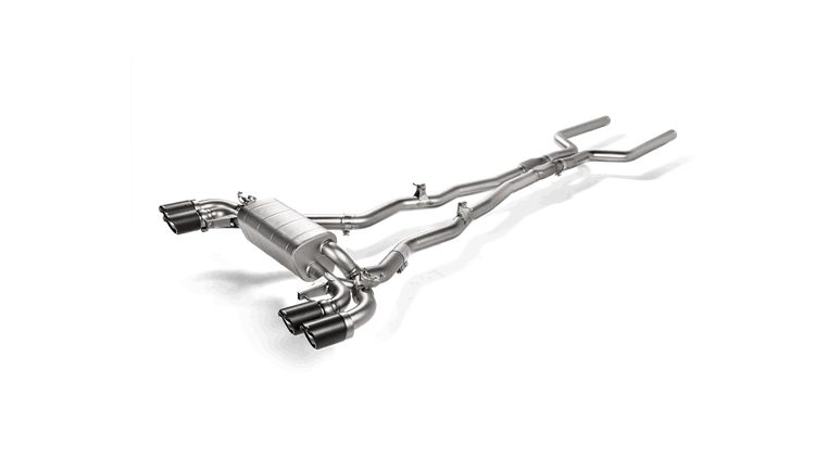 Aerial side view of a titanium Akrapovič exhaust system with silencers and quad carbon fibre tips