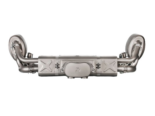 Front image of an Akrapovič dB reducer in Titanium with the Akrapovič logo stamped on the front surface, fitted to the rear exhaust