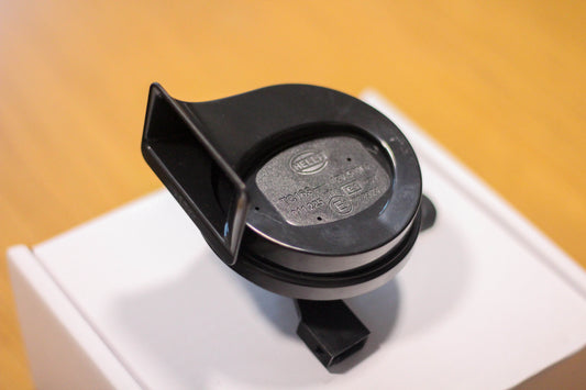 Aerial view of a black Hella horn sitting on top of a white box