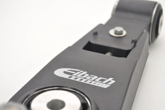Close up view of a black Eibach adjustable camber lower arms showing the central bush & end bush