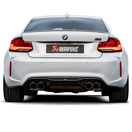 Side rear view of a White BMW M2 with an Akrapovic exhaust, with twin carbon tips each side, fitted