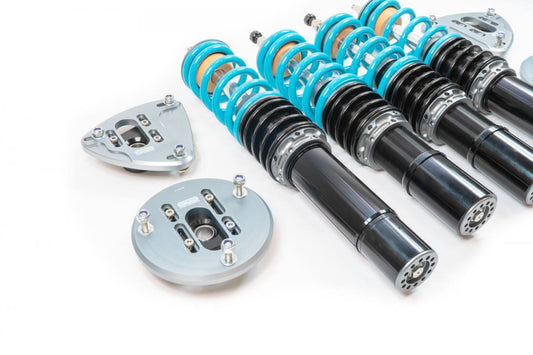 Aerial view of a Nitron R1 911 9971 GT3 kit with all the components, which include 4 shock absorbers with the coil attached, 4 top mounts & a pair of rods, all laid out on a white surface