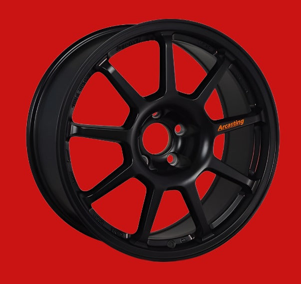 Front view of a Z.A.R Corse 18-inch black wheel with a 9-spoke design against a red background