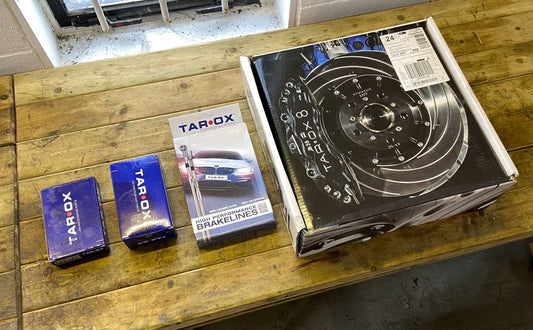 Aerial view, from left to right, of a pair of Tarox brake pad boxes, a Tarox High Performance Braklines box & a Tarox brake disc box