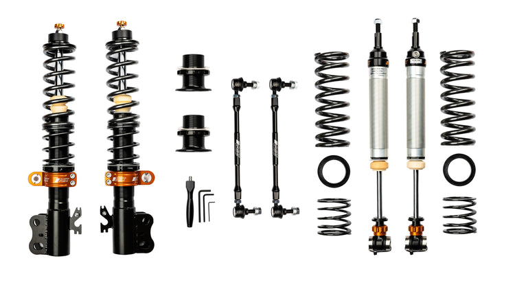 Aerial view of an AST 4100 kit showing 4 AST shock absorbers, 4 springs, 2 top mounts & fitting tools