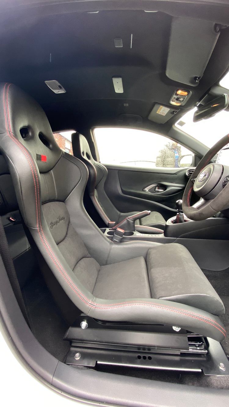 Image showing the interior of a Toyota GR Yaris with Cobra Nogaro Circuit GR Yaris seats, String Theory Garage Signature Edition, lowering seat kit & an Alcantara black steering wheel with red stitching