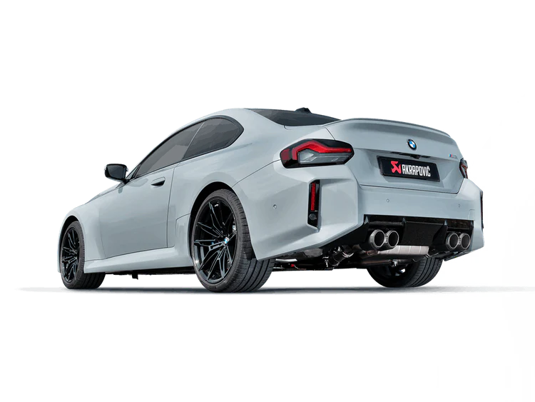 Nearside rear view of a grey BMW M2 G87 with black alloy wheels & an Akrapovič Titanium twin pipe double round exhaust fitted
