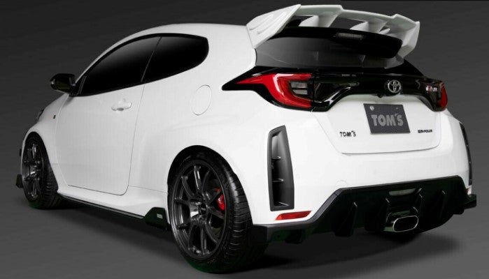 Nearside rear view of White Toyota GR Yaris with black trim, fitted with a TOM'S rear spoiler painted white