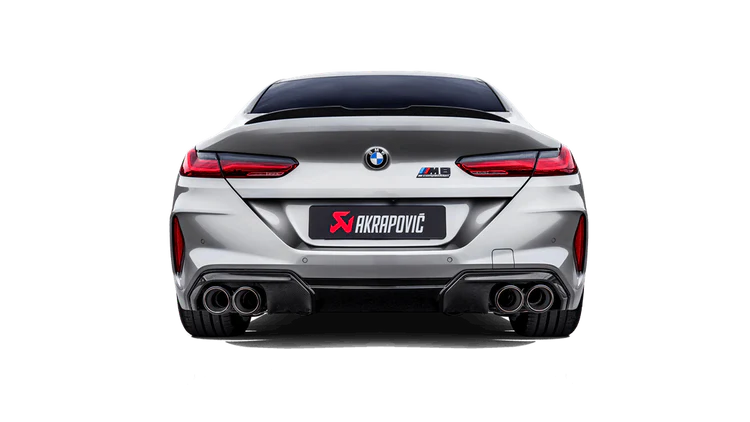 Rear view of a silver BMW M8 with an Akrapovič, twin pipes each side, exhaust fitted