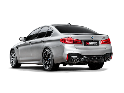 Rear view of a silver BMW M5 F90 with an Akrapovic Titanium rear exhaust with twin pipes each side, carbon fibre tips & a carbon fibre rear diffuser