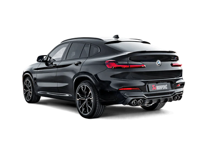 Nearside rear view of a black BMW X4M with an Akrapovič exhaust with twin pipes each side fitted