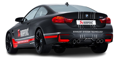 Near side rear view of a matt black BMW M4 with an Akrapovic exhaust, with twin pipes each side, & a carbon fibre rear diffuser fitted
