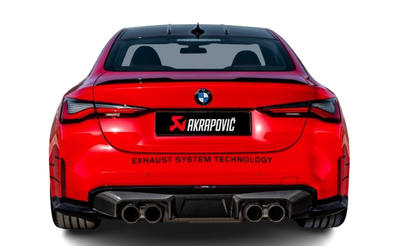 Rear view of a red BMW M3 with an Akrapovic exhaust, with twin pipes each side, & a high gloss black rear diffuser fitted