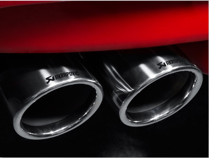 Close up view of a pair of Akrapovic Titanium tail pipes fitted to a red vehicle