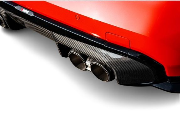 Close-up of a red car's rear with Akrapovic carbon fibre exhaust tips and diffuser fitted