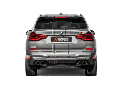 Rear view of a silver BMW X3M with an Akrapovič exhaust with twin pipes each side fitted