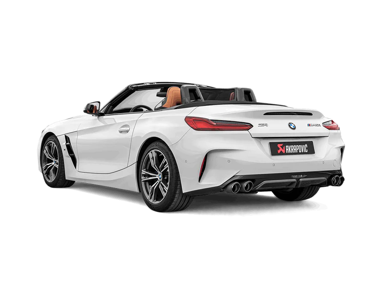 Nearside rear view of a white BMW Z4 M40i with an Akrapovič exhaust, with twin pipes each side, and a carbon fibre rear diffuser fitted