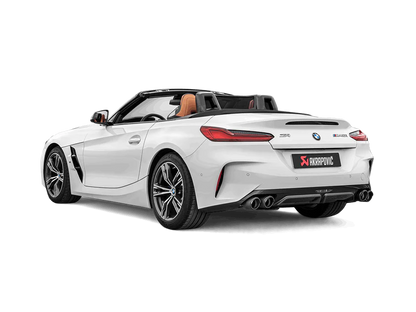 Nearside rear view of a white BMW Z4 M40i with an Akrapovič exhaust, with twin pipes each side, and a carbon fibre rear diffuser fitted