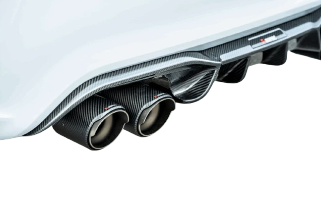 Close-up of a white car's rear with Akrapovic carbon fibre exhaust tips and diffuser