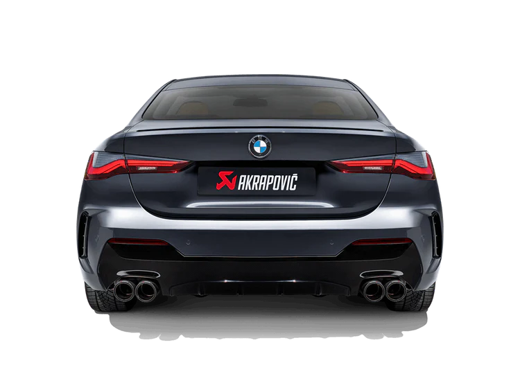 Rear view of a dark grey BMW with an Akrapovic exhaust, with twin pipes each side, fitted
