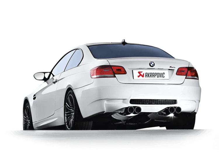 Near side rear view of a white BMW M3 with an Akrapovic carbon tail pipe set