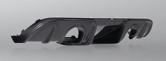 Front side view of an Akrapovič carbon fibre rear diffuser, with a high gloss finish, showing its complex geometry and aerodynamic design