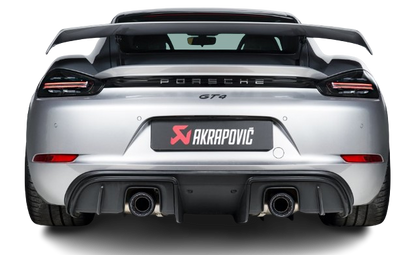 Rear view of a silver Porsche GT4 with an Akrapovič exhaust, with a pipe each side, fitted