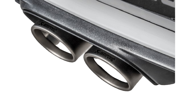 Close up view of an Akrapovič double round Titanium tail pipe set fitted to a Porsche with an Akrapovič carbon fibre rear diffuser