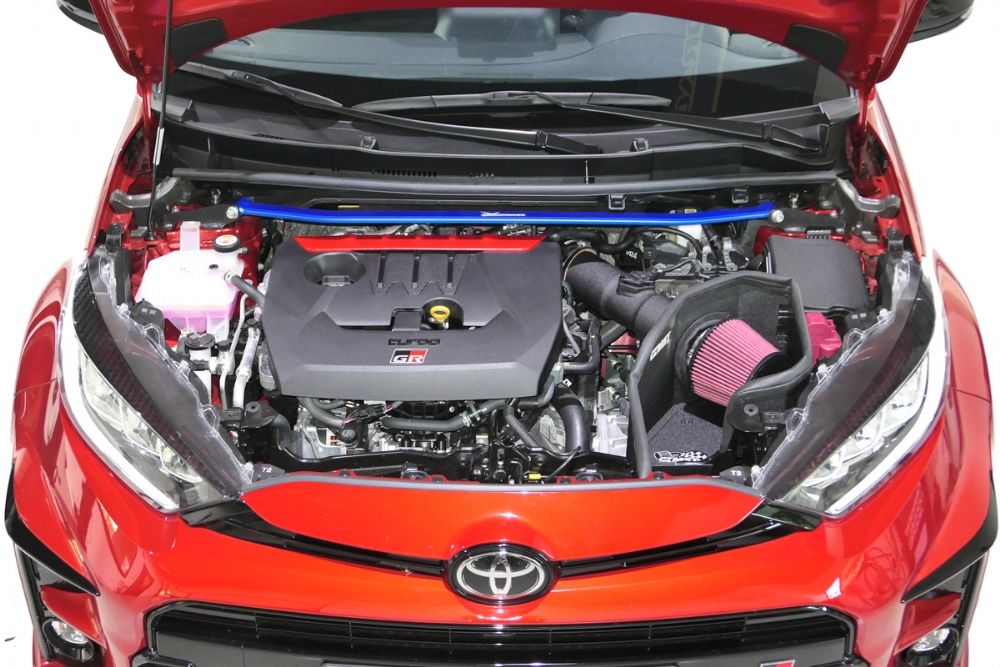 Front aerial view of a Hardrace Front Strut Bar in Blue fitted to a red car 