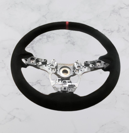 Front view of a Toyota GR Yaris steering wheel in black Alcantara with a red centre stripe & stitching, without the central facia parts