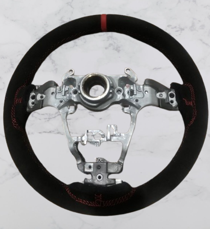 Rear view of a Toyota GR Yaris steering wheel in black Alcantara with a red centre stripe & stitching, without the central facia parts