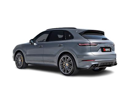 Nearside rear view of a Porsche Cayenne Turbo in silver/white with an Akrapovič Titanium twin, double round carbon fibre tail pipe fitted.