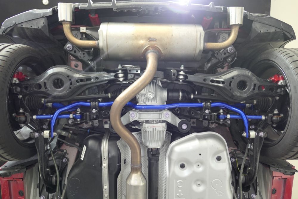 View of the underside of a Toyota GR Yaris showing a blue, rear anti roll bar fitted