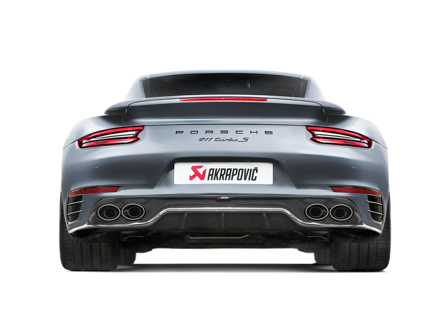 Rear view of a Grey Porsche with an Akrapovič carbon fibre rear diffuser with double twin oval tail pipes in a high gloss finish fitted