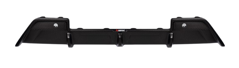 A top-down view of an Akrapovič carbon fibre rear diffuser with a high gloss finish, showing its complex geometry and aerodynamic design