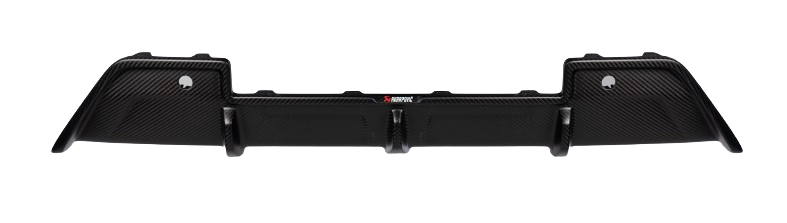 A top-down view of an Akrapovič carbon fibre rear diffuser with a matte finish, showing its complex geometry and aerodynamic design