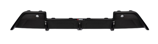 A top-down view of an Akrapovič carbon fibre rear diffuser with a matte finish, showing its complex geometry and aerodynamic design