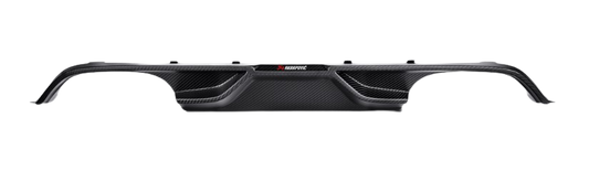 A rear view of an Akrapovič carbon fibre rear diffuser showing its complex geometry and aerodynamic design