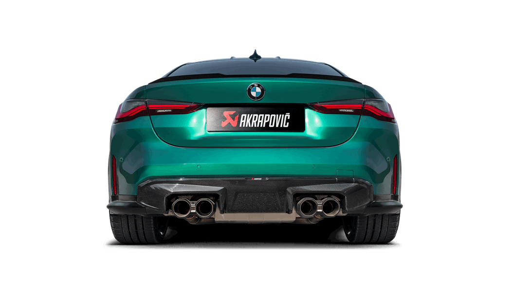 Rear floor level view of a green BMW M4 with an Akrapovic exhaust, with twin pipes each side, and a rear carbon fibre diffuser fitted