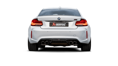 Side rear view of a White BMW M2 with an Akrapovic exhaust, with twin carbon tips each side, fitted