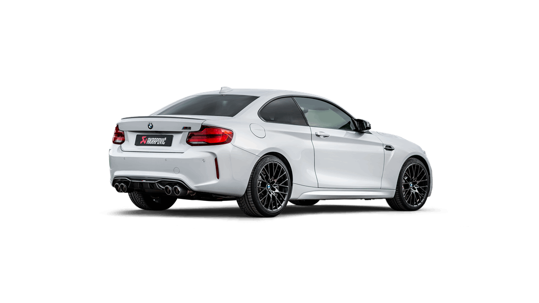 Side rear view of a white BMW M2 with an Akrapovic exhaust system, with quad carbon fibre tips, fitted