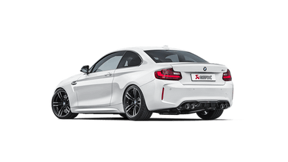 White BMW M2 with Akrapovic exhaust and twin pipes on each side, side rear view