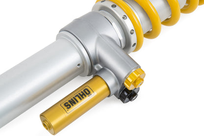 Close up view of an  Öhlins racing coilover with adjusting dials & separate reservoir