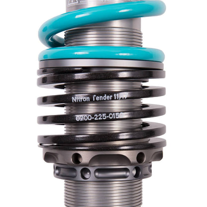 Close up of part of a shock absorber, light blue coil spring & black coil spring