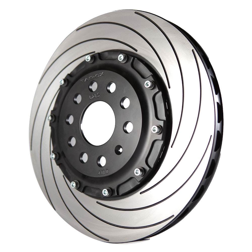 Slightly off front image of a single Tarox brake disc showing the side vents, groves on the disc surface & removable centre. The hub fitting has 9 holes & 1 locating hole